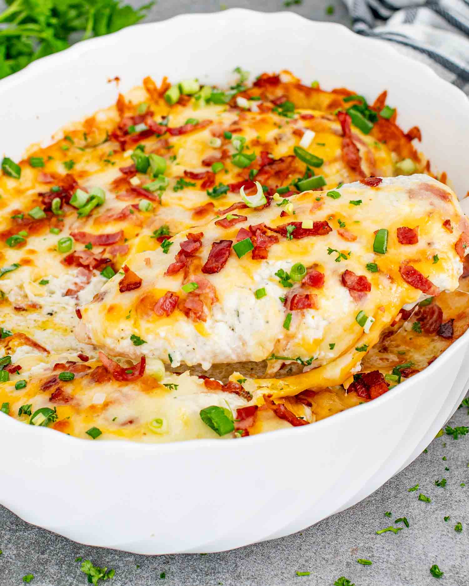 fresh out of the oven baked crack chicken casserole in a white casserole dish.