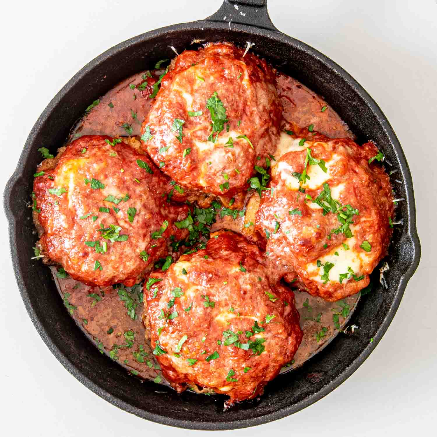 process shots showing how to make italian style hamburger steaks.