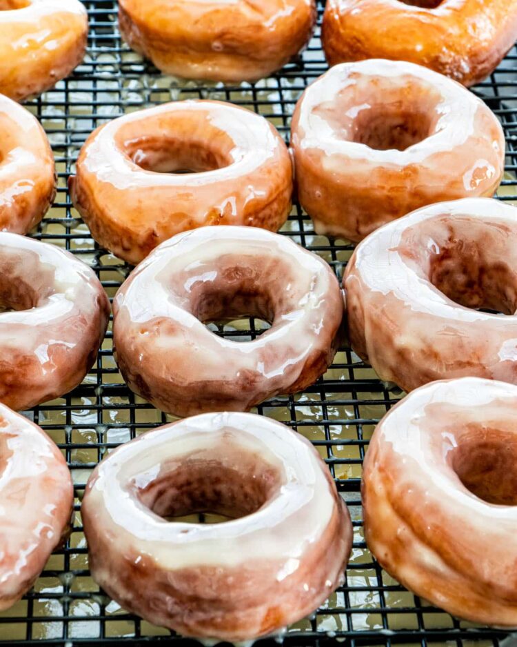 freshly made krispy kreme donuts on a cooling rack
