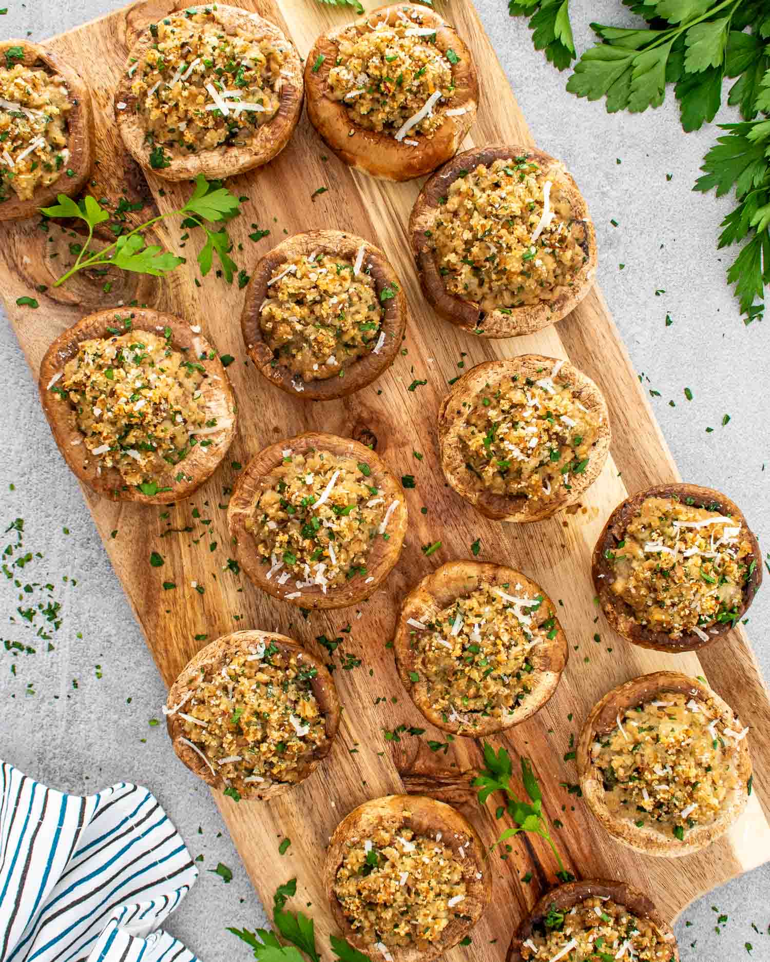 stuffed mushrooms on a cutting board.