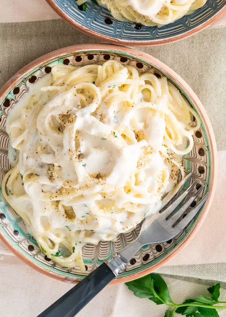 Easy Pasta Alfredo overhead shot of a plate of alfredo pasta and a fork