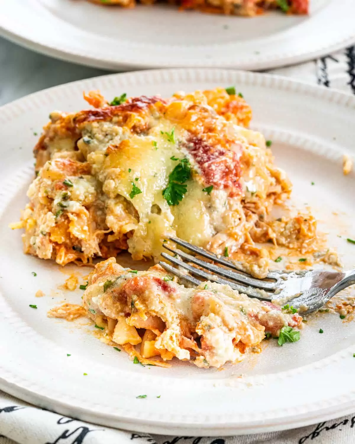 Buffalo Chicken Lasagna a slice of Buffalo Chicken Lasagna on a white plate