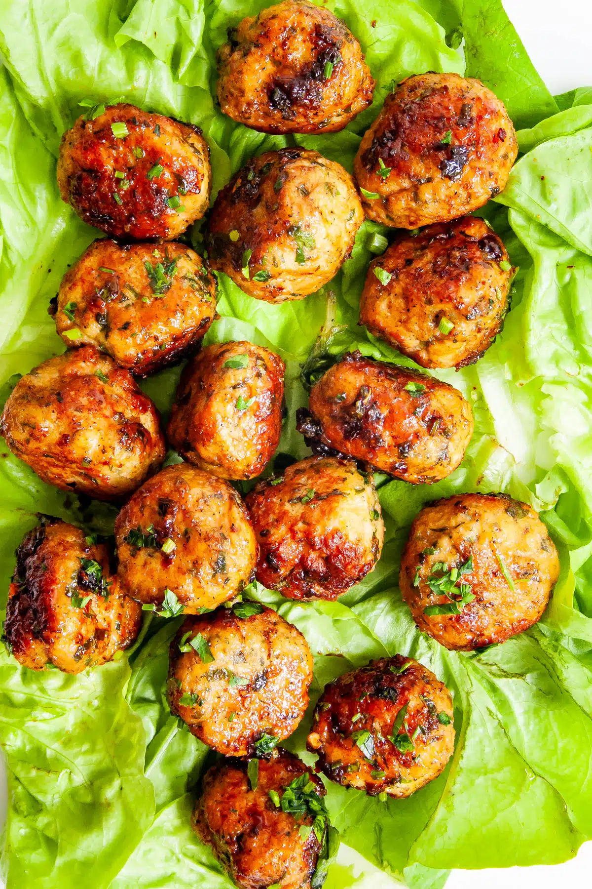 Firecracker Chicken Meatballs Firecracker Chicken Meatballs over lettuce leaves